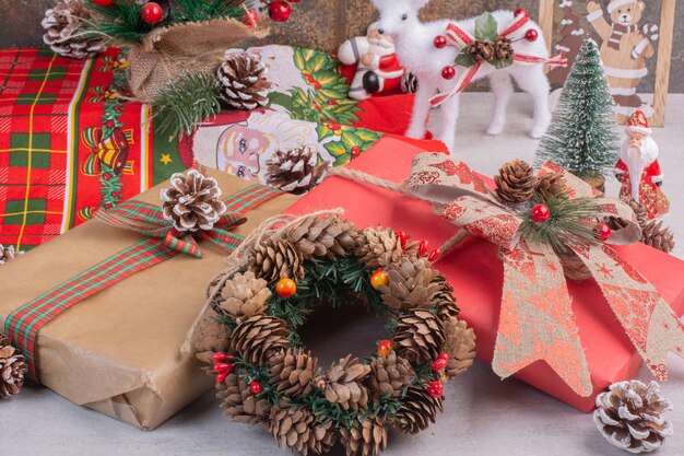 Christmas wreath with gift boxes on white surface