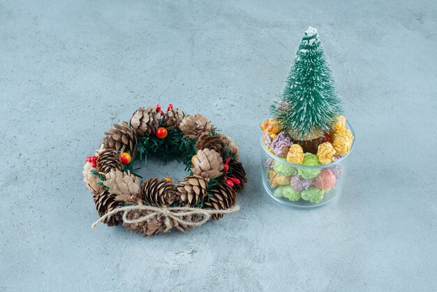 A Christmas Wreath With Tree And Colorful Popcorn.