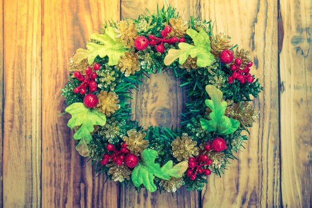 Christmas wreath Over Wooden Background  ( Filtered image proces