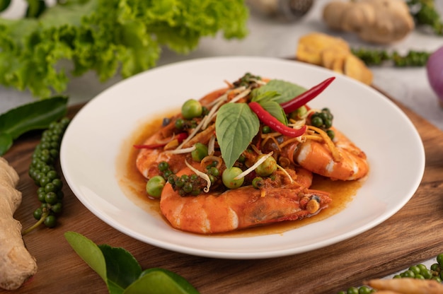 Chuchi shrimp on a plate with fresh pepper seeds