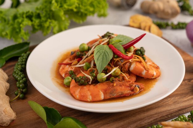 Chuchi shrimp on a plate with fresh pepper seeds