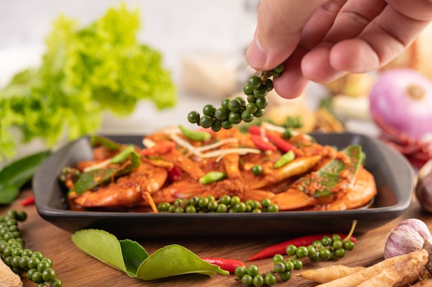 Chuchi shrimp on a plate with fresh pepper seeds