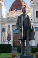 Free photo church of the annunciation and statue of emil dandea of targu mures romania