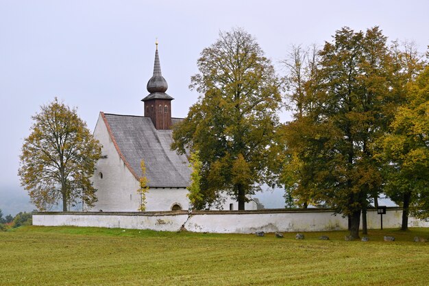 "Church in small autumnal grove"