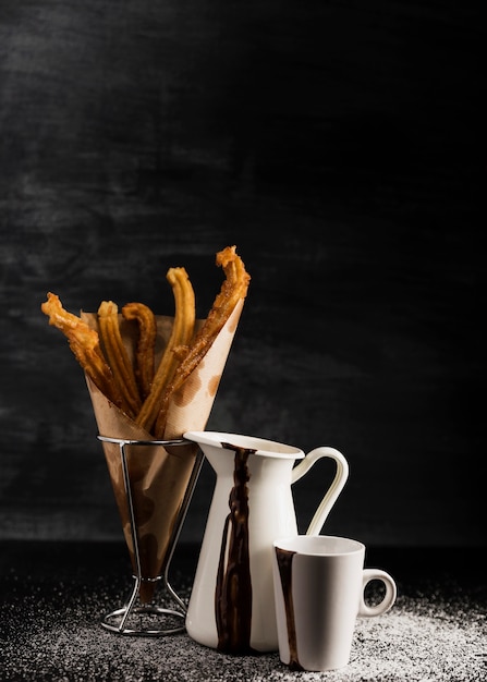 Churros in a glass and black copy space background