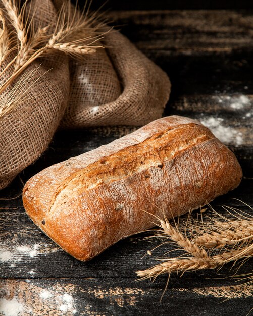 ciabattbread with flour and wheat on table