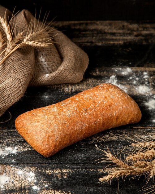 ciabattbread with wheat on table and