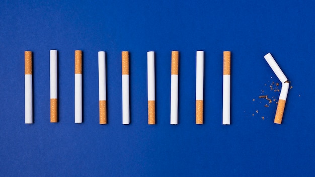 Cigarettes arrangement on blue background