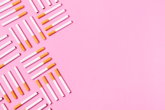 Free photo cigarettes frame on pink background