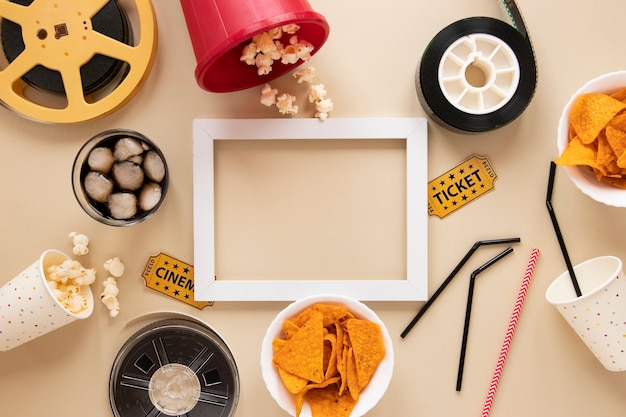 Cinema elements on beige background with white empty frame