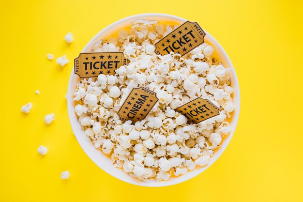 Cinema tickets in bucket with popcorn