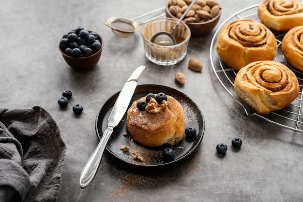 Cinnamon roll with blueberries high angle