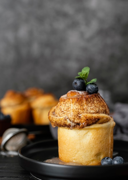 Free photo cinnamon rolls with blueberries arrangement