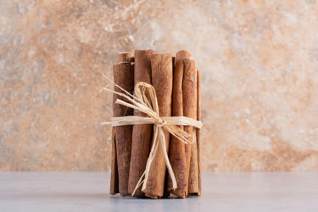 Cinnamon sticks isolated on concrete background.