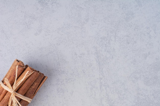 Cinnamon sticks isolated on concrete background.