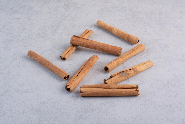 Cinnamon sticks isolated on concrete background. 