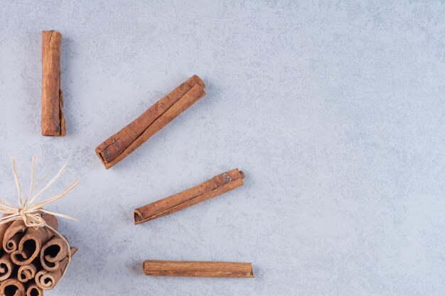 Cinnamon sticks isolated on concrete background.