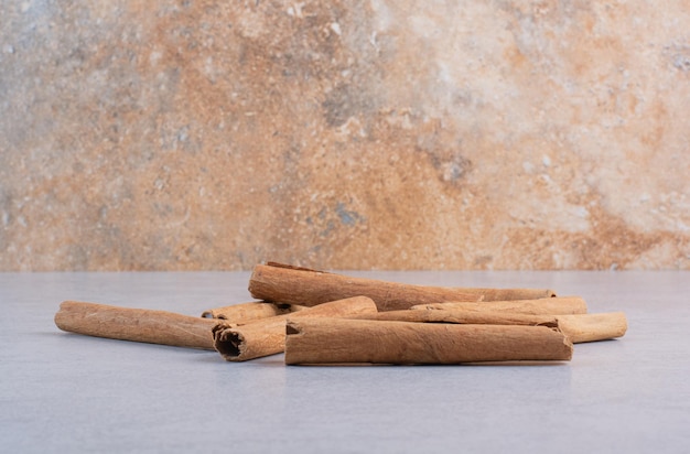 Cinnamon sticks isolated on concrete background. 