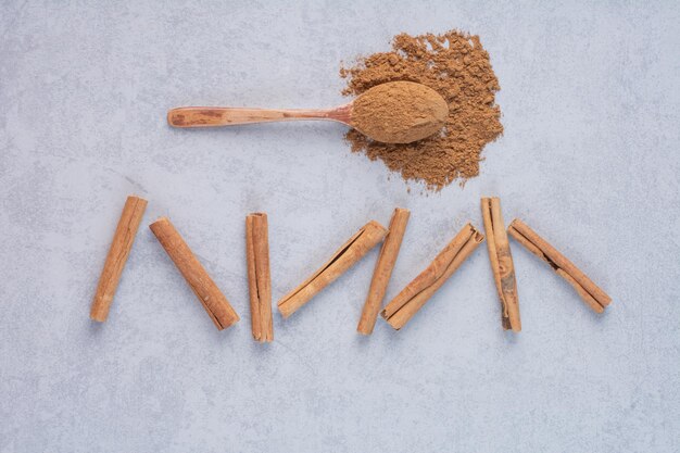 Cinnamon sticks isolated on concrete background. 