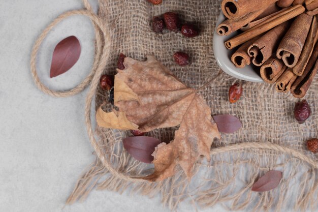 Cinnamon sticks, leaves and rope on burlap. High quality photo