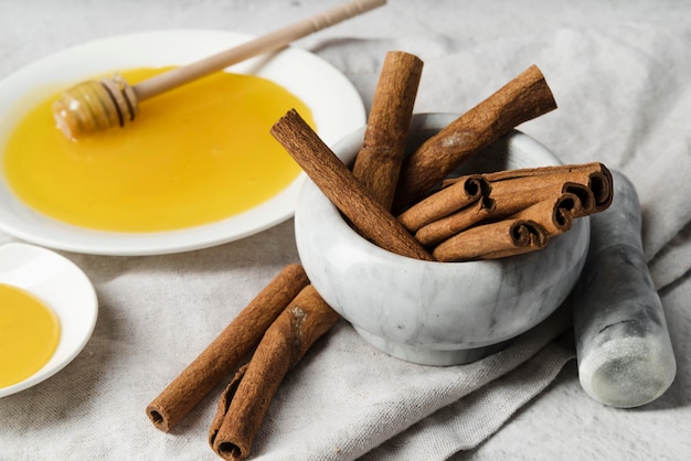 Cinnamon sticks with honey and honey dipper