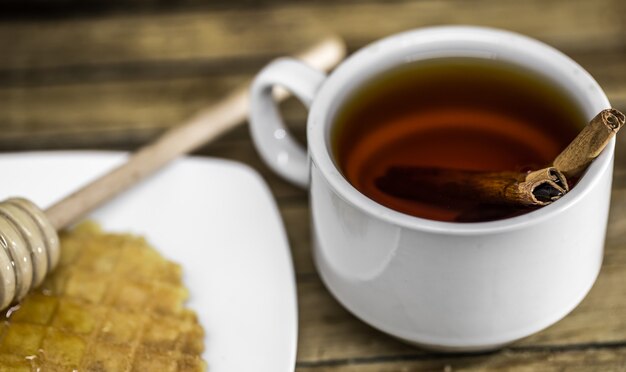 Cinnamon tea with honey dipper