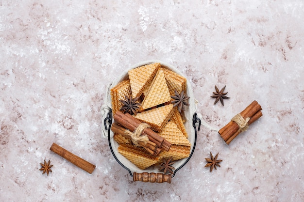 Cinnamon waffles on grey concrete table, top view