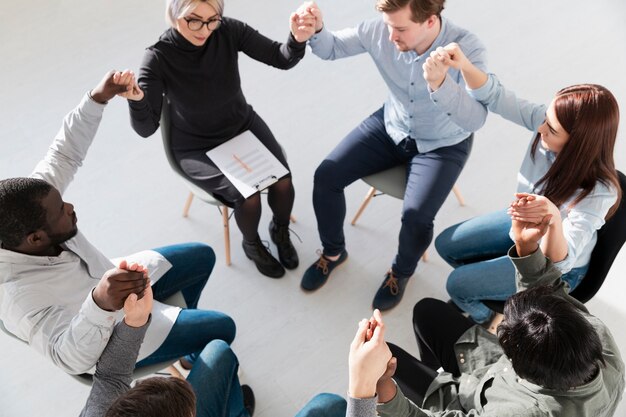 Circle of people raising their hands