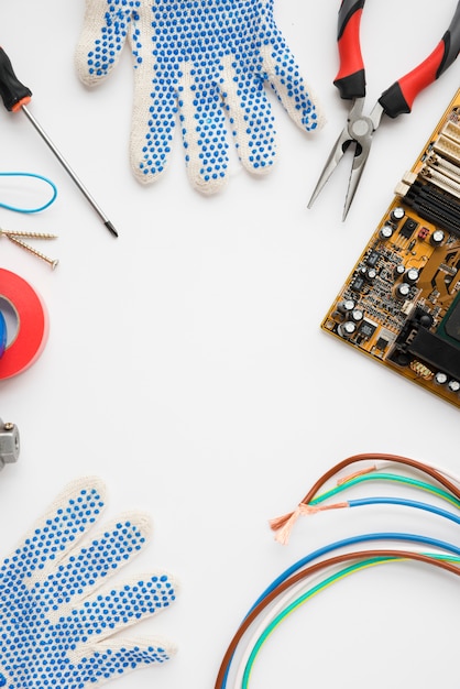 Circuit board; glove and electric equipment isolated on white background