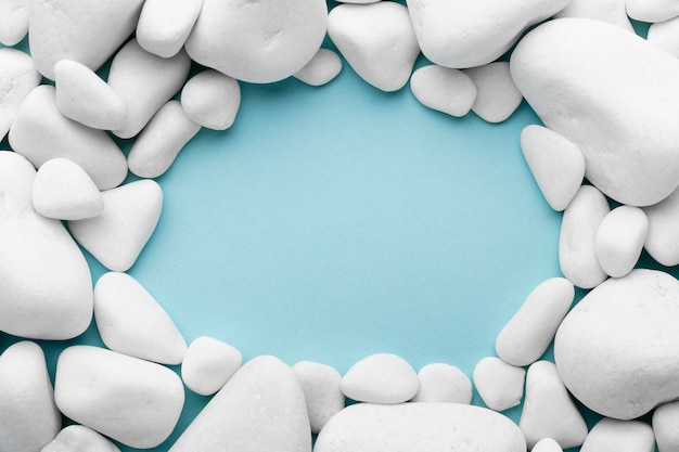 Circular frame with pebbles on blue background