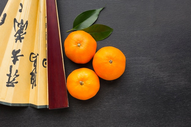 Free photo citrus for chinese new year and fan