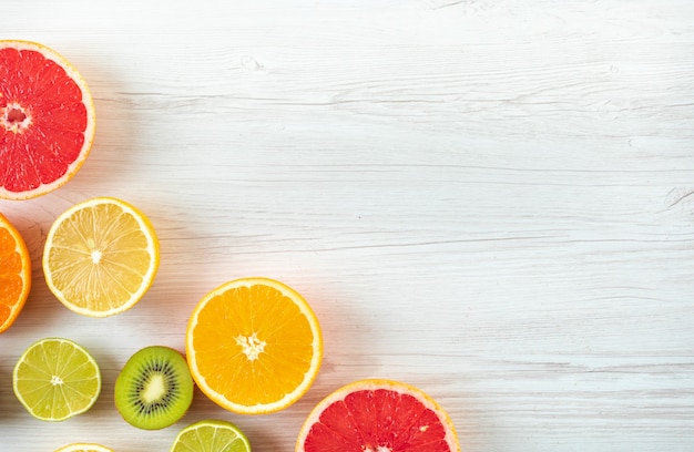 Citrus fruit slices top view with copy space on wood surface