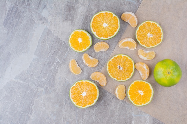Citrus fruits scattered on stone background. 