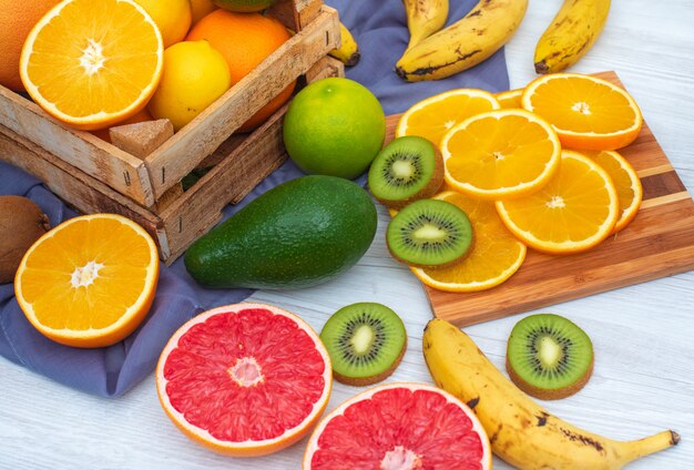 citrus fruits in wooden box and cutting board