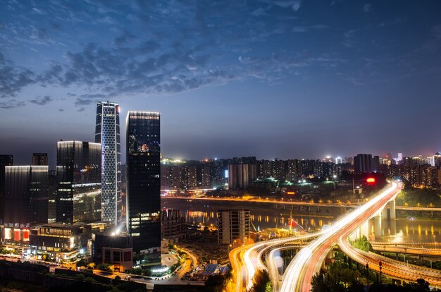 city interchange overpass at night with purple light show in chong qing