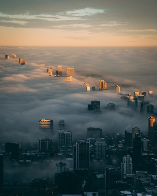City skyline with a layer at fog at sunrise viewed from above