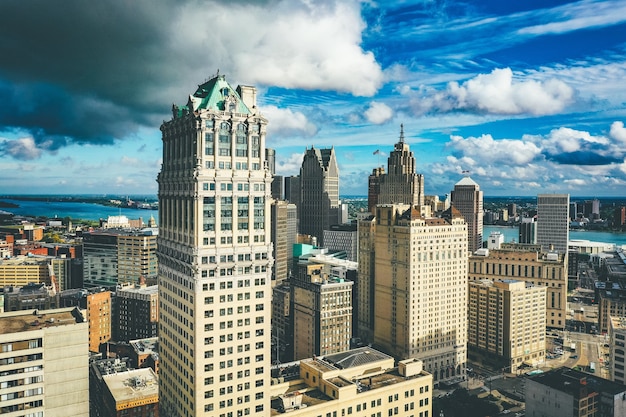 Cityscape of Detroit under the sunlight and a dark cloudy sky at daytime