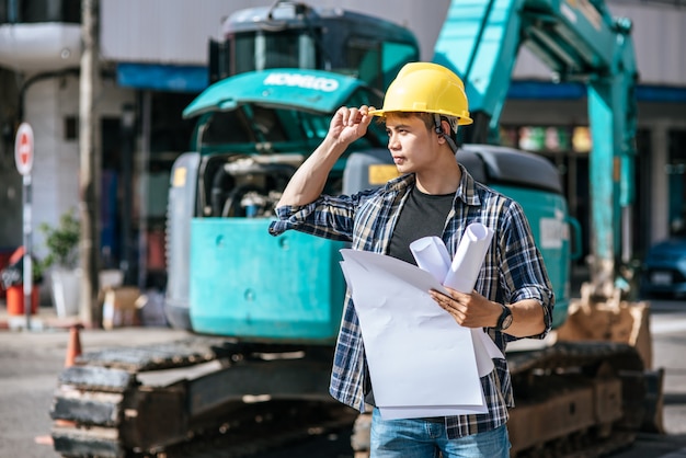 Free photo civil engineers work on large road and machinery conditions.