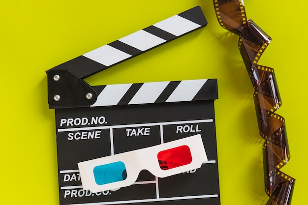 Clapboard near carton 3d glasses and tape