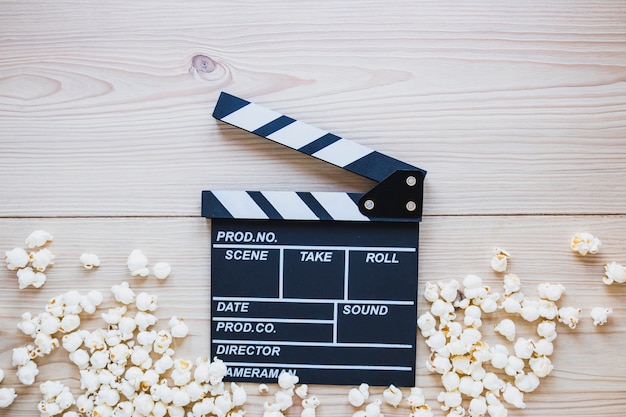 Clapboard with popcorn on wood