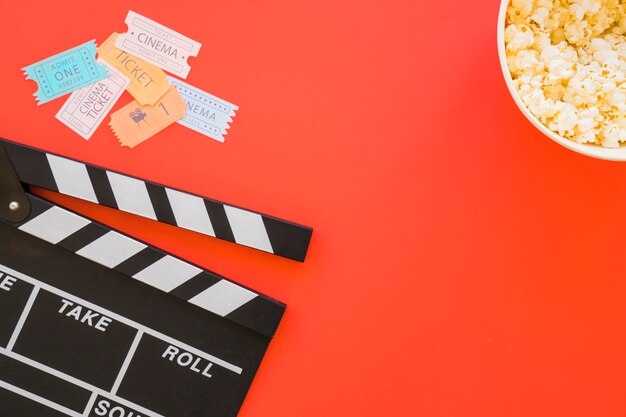 Clapperboard, movie tickets and popcorn