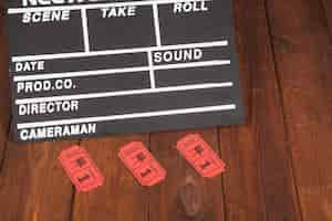 Free photo clapperboard and red tickets