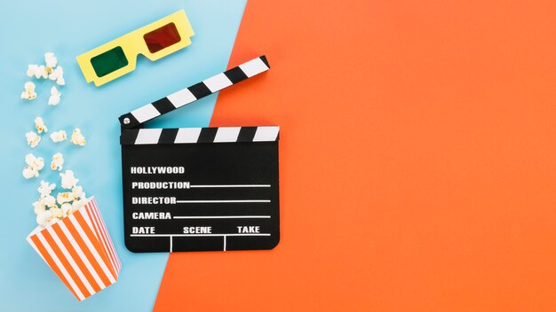 Clapperboard with 3d glasses and popcorn