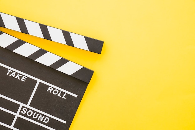 Free photo clapperboard on yellow background