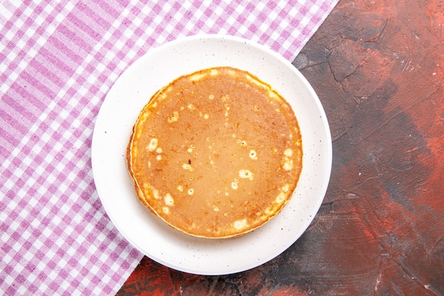 Classic American tasty pancakes on a pink stripped towel on mixed color