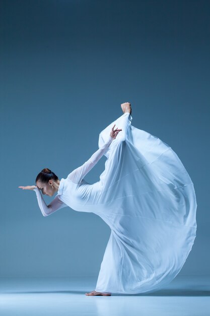 Classic ballerina dancing on blue