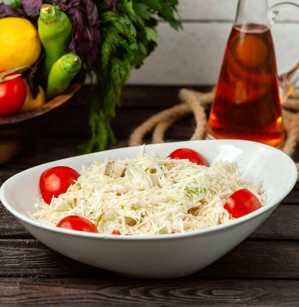 Classic caesar salad with chicken on the table on the table