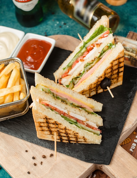 Classic club sandwich with fries and sauce