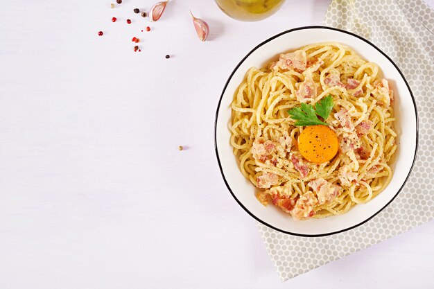 Classic homemade carbonara pasta with pancetta, egg, hard parmesan cheese and cream sauce.