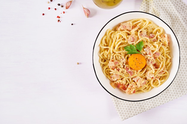 Classic homemade carbonara pasta with pancetta, egg, hard parmesan cheese and cream sauce.